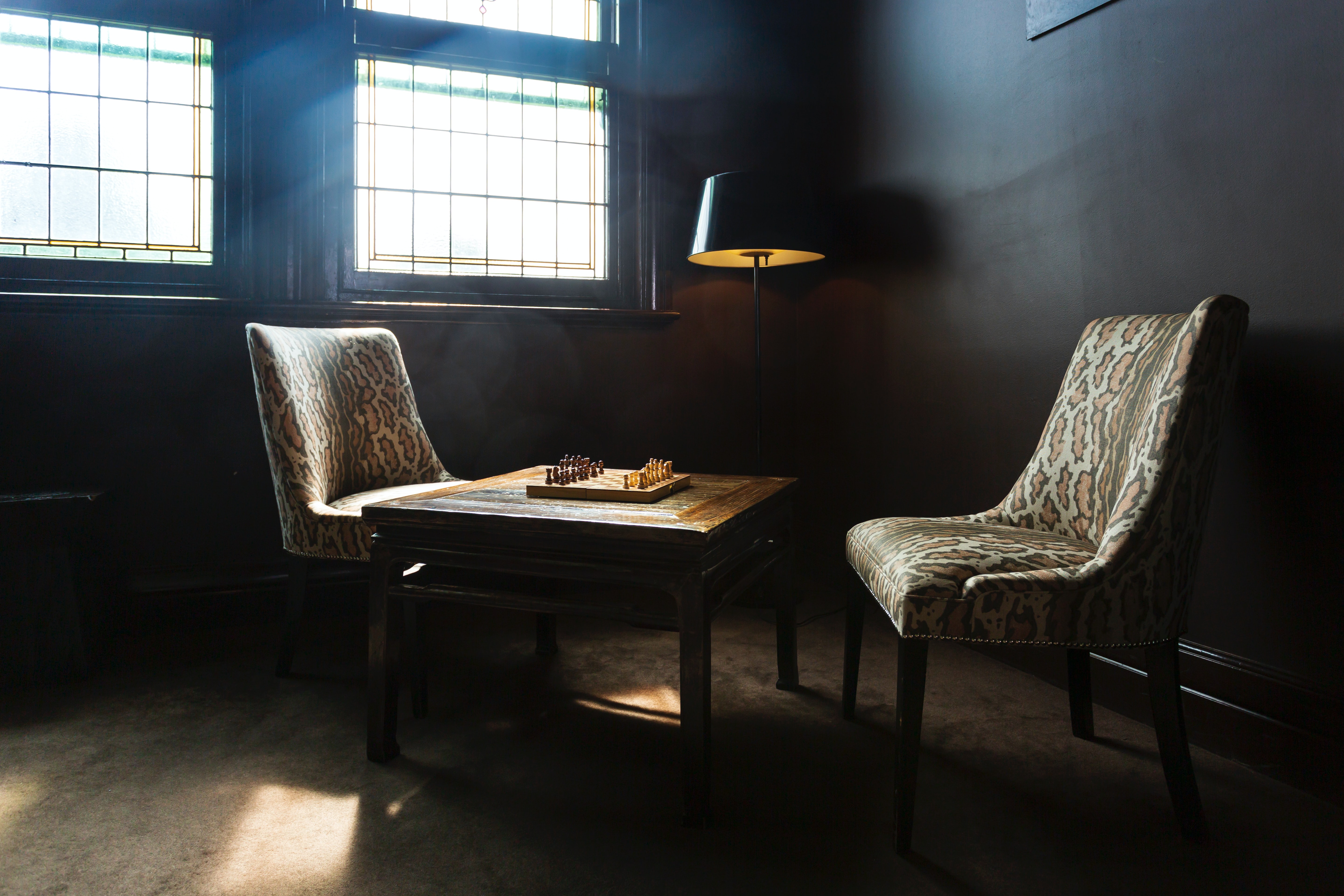 Image of a chess board on a table with two chairs